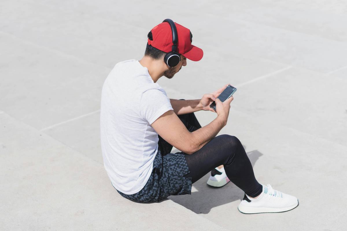 Image showing a person meditating with a phone displaying an emotional wellness app